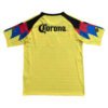 Yellow Manchester United third jersey with black accents and colorful sleeve details, featuring Coro.