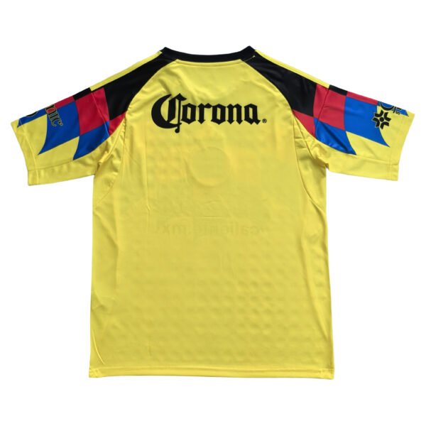 Yellow Manchester United third jersey with black accents and colorful sleeve details, featuring Coro.