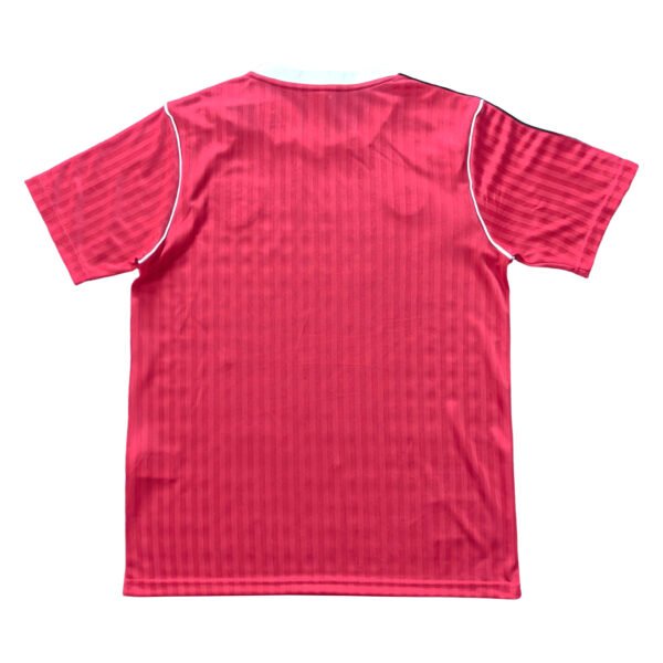 Manchester United third soccer jersey for 2025/26 season, red with white accents.