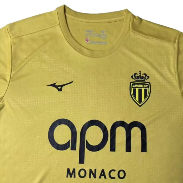 Manchester United third kit 2025/26 with AS Monacofc logo, yellow color, and modern design.