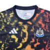 Manchester United third jersey with black, yellow, and red abstract design, club crest visible.