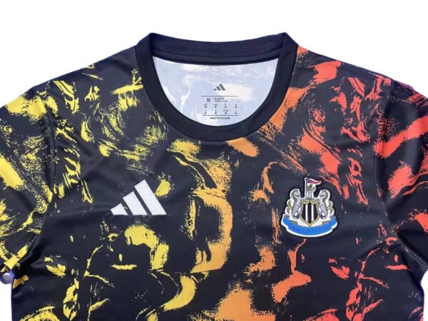 Manchester United third jersey with black, yellow, and red abstract design, club crest visible.