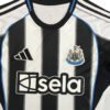 Manchester United 25/26 third kit with black and white stripes and club crest.