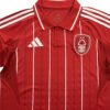 Manchester United third soccer jersey for 2025/26 season, red with white stripes.