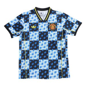 Manchester United third kit 2025/26 with bold blue and black geometric pattern.