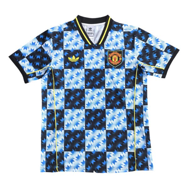 Manchester United third kit 2025/26 with bold blue and black geometric pattern.