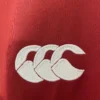 Close-up of Sportskit logo embroidered on red sports fabric.