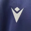 Sportswear logo on navy blue fabric, emphasizing athletic apparel branding. Close-up of a sportswear logo on navy blue fabric, highlighting quality athletic clothing branding.