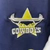 Dallas Cowboys sports team logo embroidered on navy blue fabric. Embroidered Dallas Cowboys logo featuring a star, horns, and team name on sports apparel.