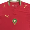 Morocco national football team jersey with Puma logo and emblem, red color, perfect for sports fans.