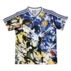 Kids' Manchester United soccer jersey with colorful abstract design and team logo.