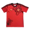 Manchester United Red Football Jersey with Black and Gold Details Manchester United red football jersey with black accents and club crest, ideal for sports fans.