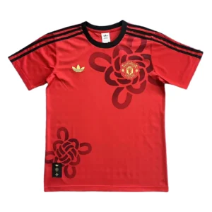 Manchester United Red Football Jersey with Black and Gold Details Manchester United red football jersey with black accents and club crest, ideal for sports fans.
