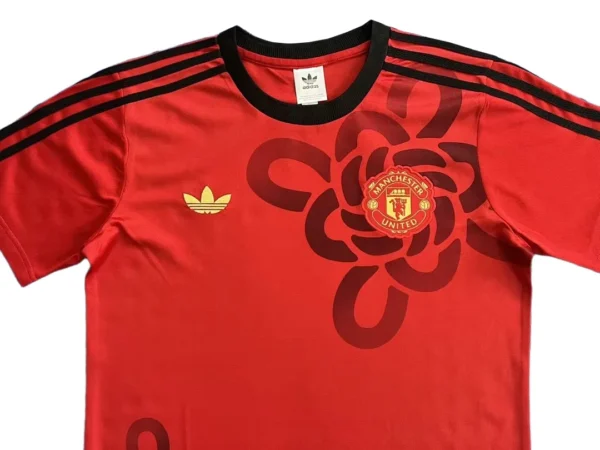 Manchester United Red Soccer Jersey with Floral Design Red Manchester United football jersey featuring floral pattern and black accents, ideal for sports a.