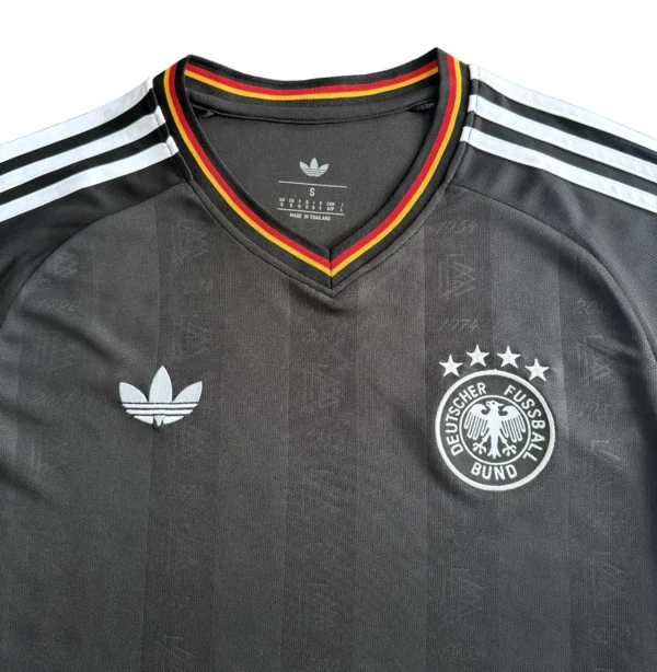 Germany national football team jersey with Adidas logo and Deutscher Fussball Bund emblem. Germany football jersey with Adidas logo and national team badge, ideal for sports fans and athletes.