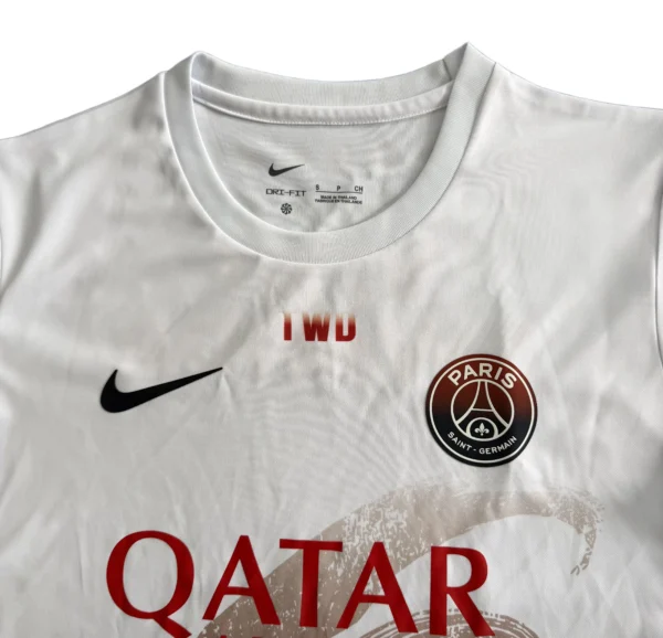 Paris Saint-Germain white soccer jersey with Nike logo, Qatar sponsor, and IWD text, ideal for sport.