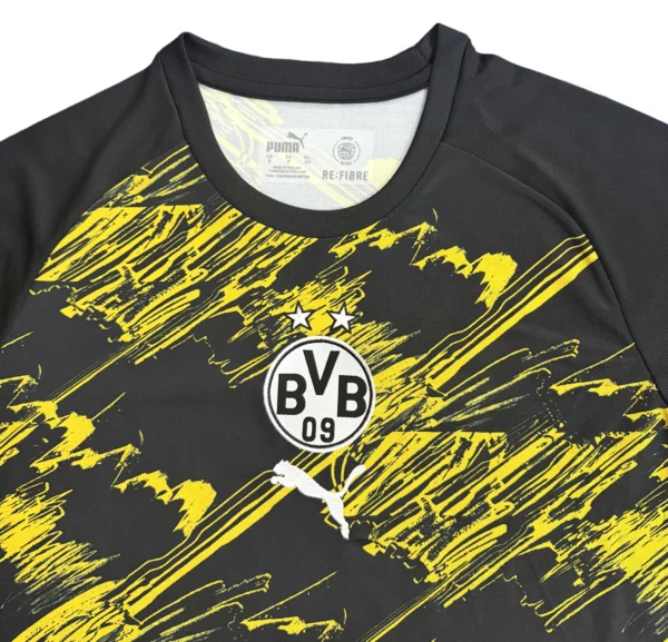 Borussia Dortmund black and yellow football jersey with club logo and Puma branding.