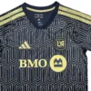 Football jersey with BMO logo and geometric pattern, black and gold design. Football jersey with BMO logo, geometric pattern, and gold accents for sports fans.