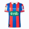 Football jersey with red and blue vertical stripes, featuring sponsor logos and team emblem.