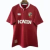 Sports jersey featuring team crest, sponsor logo, and Canterbury branding for athletic performance a.