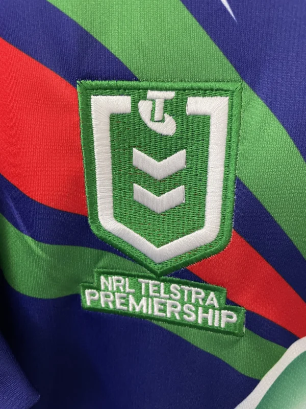 NRL Telstra Premiership team badge on sports jersey, close-up view.