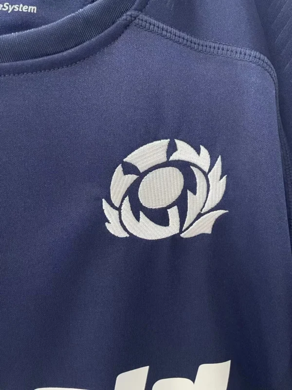 Sportswear logo on navy athletic shirt Athletic shirt with sportswear logo, ideal for training and active lifestyles.