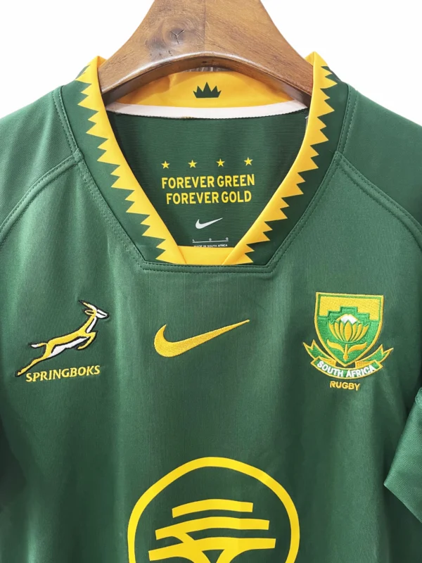 South Africa Rugby Jersey with Green and Gold Design South Africa rugby jersey featuring green and gold colors with team logos and sponsor details.