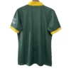 Green sports jersey with yellow accents, back view, suitable for athletic wear.