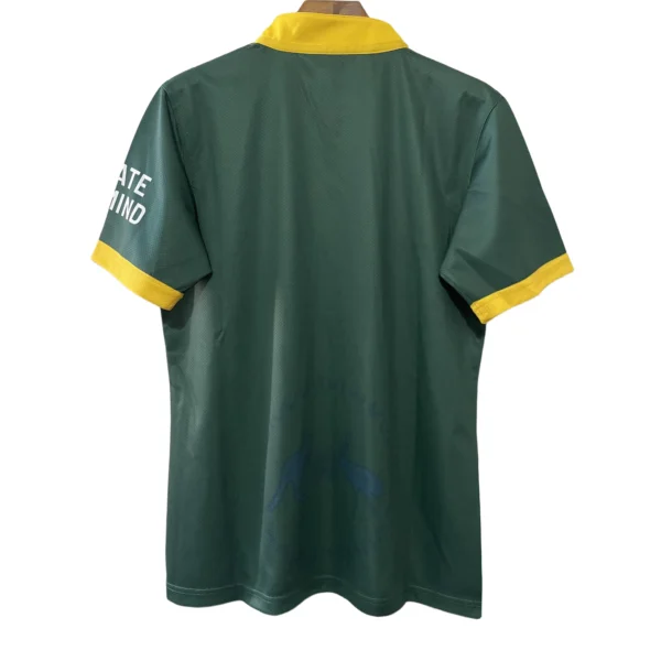 Green sports jersey with yellow accents, back view, suitable for athletic wear.