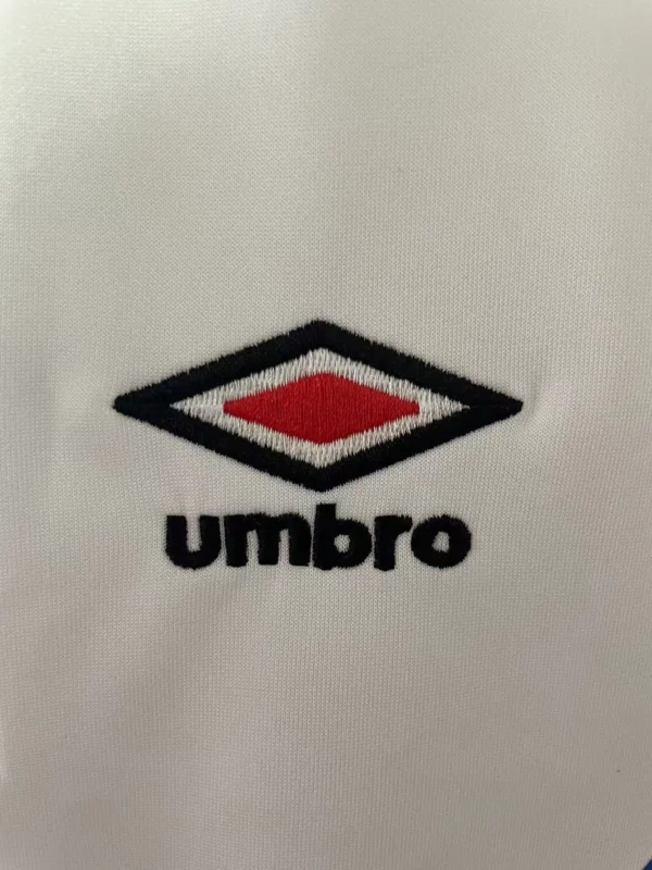 Sportswear Umbro logo embroidered on fabric. Umbro sportswear logo embroidered on fabric.