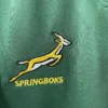 Springboks Rugby Jersey Logo Springboks rugby team logo embroidered on green sports jersey.