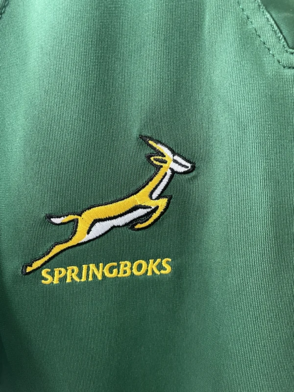 Springboks Rugby Jersey Logo Springboks rugby team logo embroidered on green sports jersey.